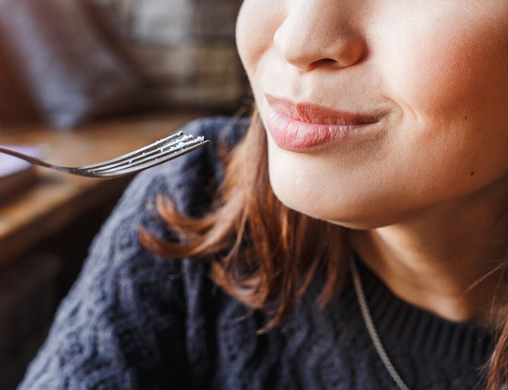 taking a bite and smiling