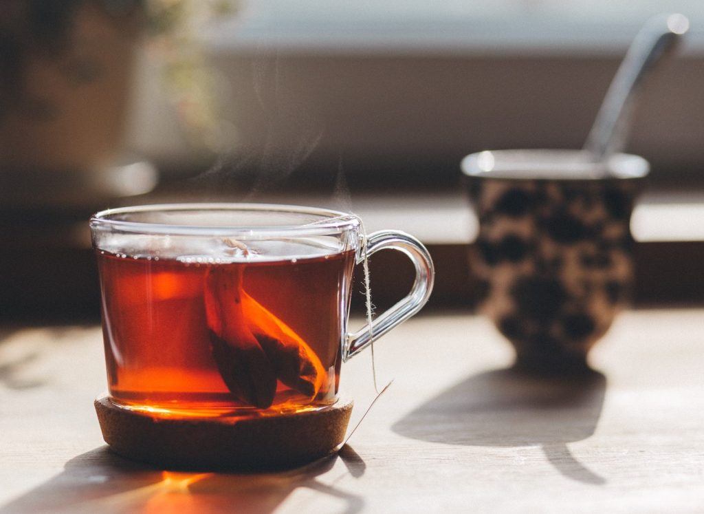 tea brewing from tea bags in a glass mug