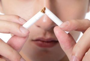 breaking the cigarette to represent quitting smoking