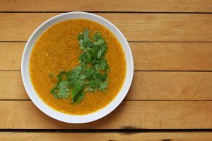 red lentil soup flavored with indian spices and topped with chopped cilantro