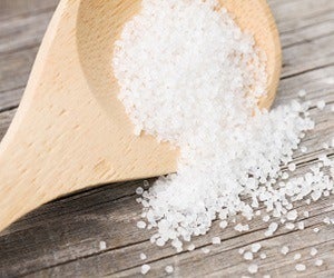 Wooden spoon full of salt
