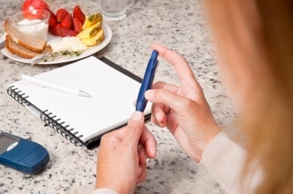 Woman checking her bloods sugar levels