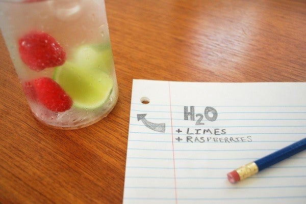 Water bottle with raspberries and limes